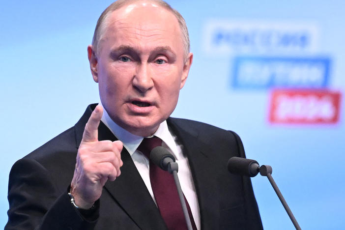 Russian President and presidential candidate Vladimir Putin meets with the media at his campaign headquarters in Moscow on Monday.