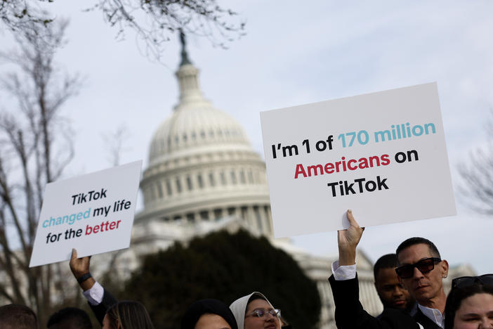 People hold signs in support of TikTok outside the U.S. Capitol building on March 13.