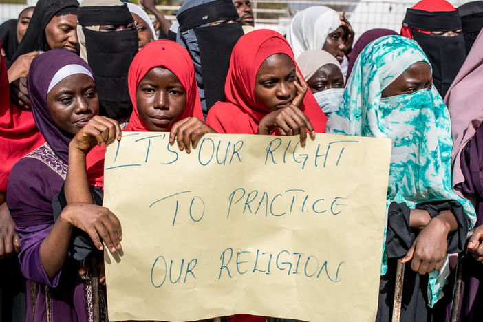 Opponents of the ban on female genital mutilation (FGM) gather outside the National Assembly in Banjul, The Gambia, on March 18, 2024. Lawmakers voted to advance a highly controversial bill that would lift the ban on FGM.