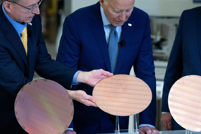Intel CEO Pat Gelsinger shows President Biden a semiconductor wafer during a tour at the company's Ocotillo Campus in Chandler, Ariz. on March 20.