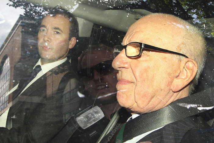 Media mogul Rupert Murdoch (right) rides with Will Lewis, then the general manager of Murdoch's News International and now <em>The Washington Post</em>'s CEO, in July 2011.