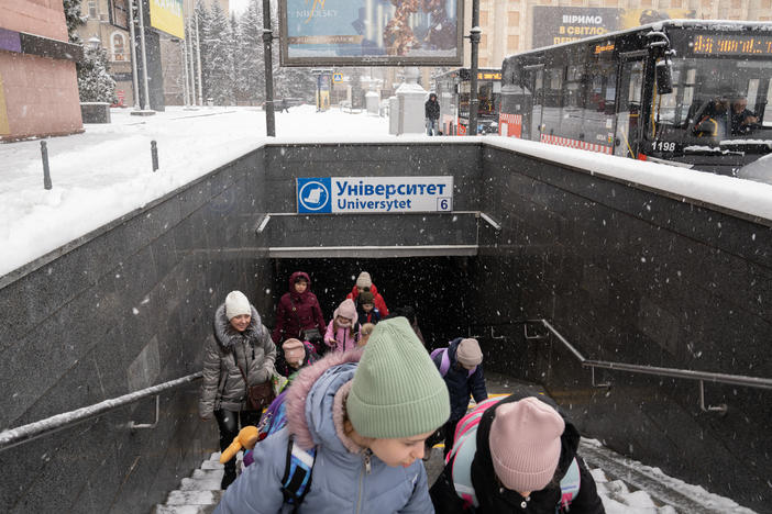 Students leave the underground school built in a Kharkiv subway station to board a bus home.