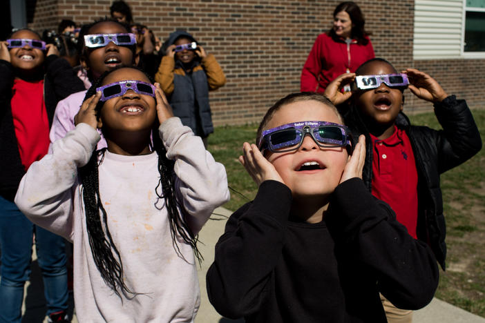 Second graders practice using solar eclipse glasses outside Winchester Village Elementary School in Indianapolis.