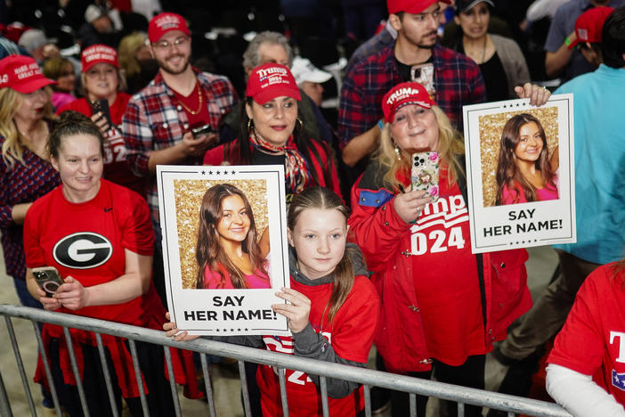 Trump supporters hold images of Laken Riley before he speaks at a rally in Rome, Ga., on March 9.