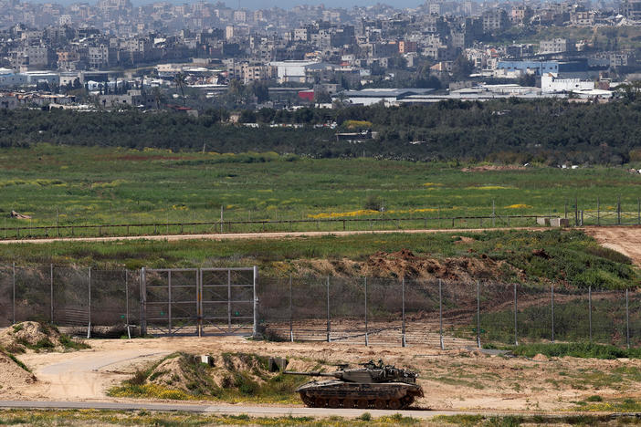 This picture taken from Israel's southern border with the Gaza Strip shows an Israeli army tank moving along the border with the Palestinian territory on March 20.