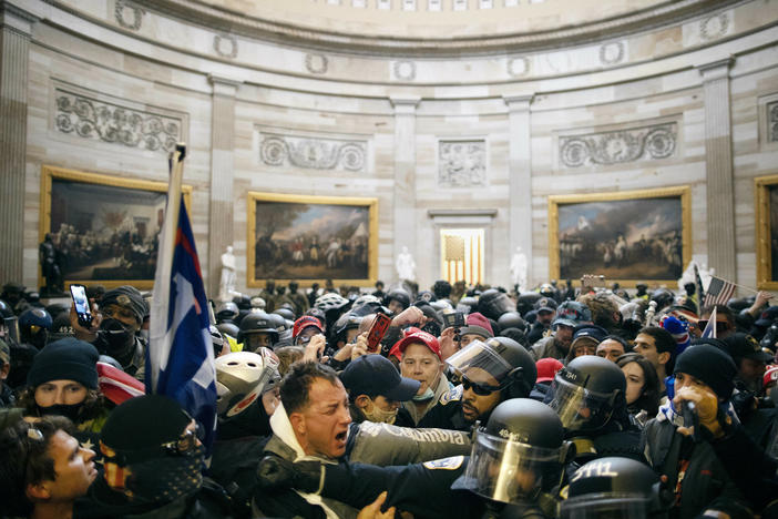 Police clash with supporters of President Donald Trump who breached security and entered the Capitol building in Washington D.C., on Jan. 6, 2021.