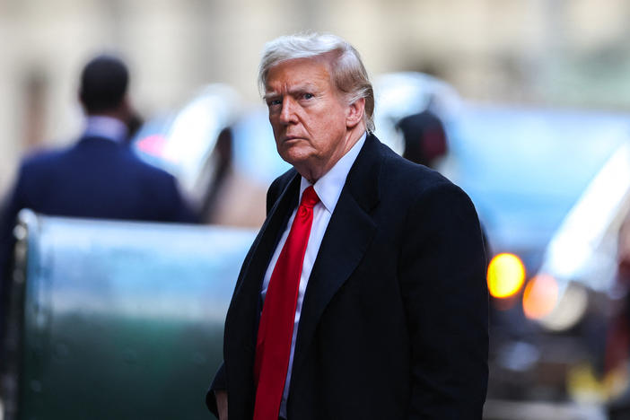 Former US President Donald Trump arrives at 40 Wall Street after his court hearing to determine the date of his trial for allegedly covering up hush money payments linked to extramarital affairs.
