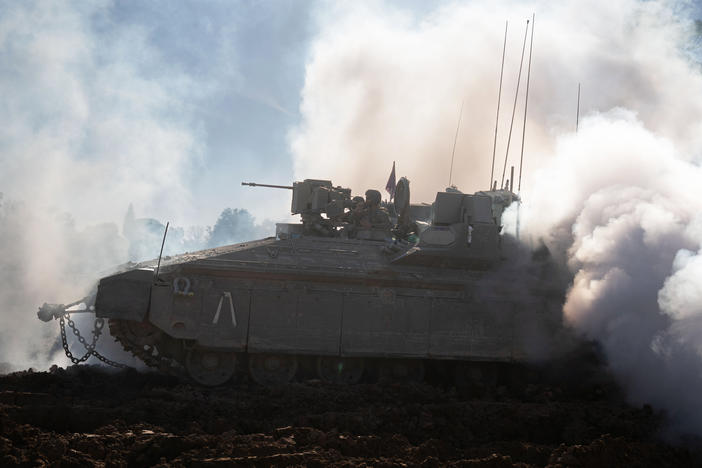 Israeli soldiers unpack their tanks and APC's to load up to trucks, after returning from Gaza on the Gaza border, Israel, Feb. 29.