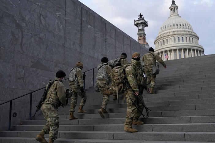 National Guard members take a staircase toward the U.S. Capitol building before a rehearsal for President-elect Joe Biden's Inauguration in Washington on Jan. 18, 2021. Experts in constitutional law and the military say the Insurrection Act gives presidents tremendous power with few restraints.