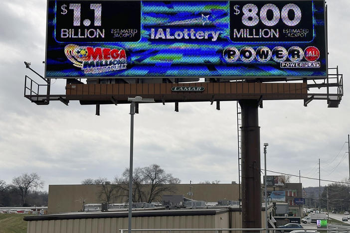 An electronic billboard advertises the Mega Millions and Powerball jackpots, Monday, March 25, 2024, in in Des Moines, Iowa, that when combined amount to nearly $2 billion.