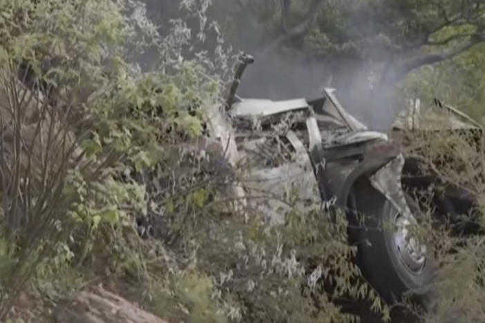 In this image taken from video provided by eNCA, a bus carrying worshippers headed to an Easter festival plunged off a bridge on a mountain pass and burst into flames in Limpopo, South Africa, on Thursday killing multiple people, authorities said.