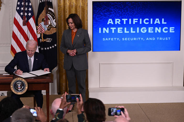 Vice President Harris watches as President Biden signs an executive order on artificial intelligence on Oct. 30. On Thursday, the Biden administration issued new rules on how government agencies can implement AI.
