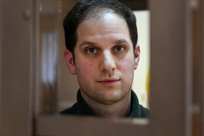 U.S. journalist Evan Gershkovich looks out from inside a defendants' cage before a hearing to consider an appeal on his extended pretrial detention, at the Moscow City Court in Moscow, on Feb. 20.