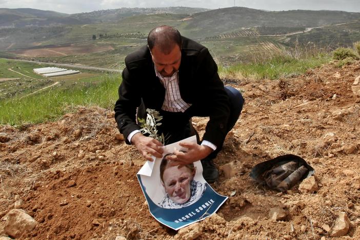 A group gathering in Qaryut village southeast of Nablus, West Bank, on March 15, 2015, plant an olive tree as they mark the 12th anniversary of the death of U.S. activist Rachel Corrie, who died when she was crushed by an Israeli bulldozer in the Gaza Strip on March 16, 2003.