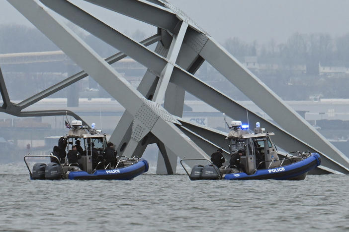 Police recovery crews work near the collapsed Francis Scott Key Bridge after it was struck by the container ship Dali in Baltimore. Eight members of a construction crew repairing potholes were on the bridge when the structure fell into the Patapsco River at around 1:30 a.m. on Tuesday.