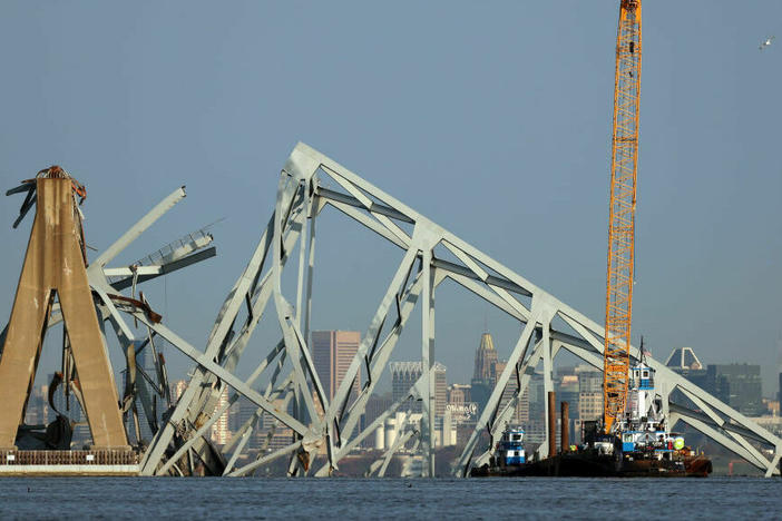 A crane is used to clear debris from the Francis Scott Key Bridge in Baltimore on Friday.