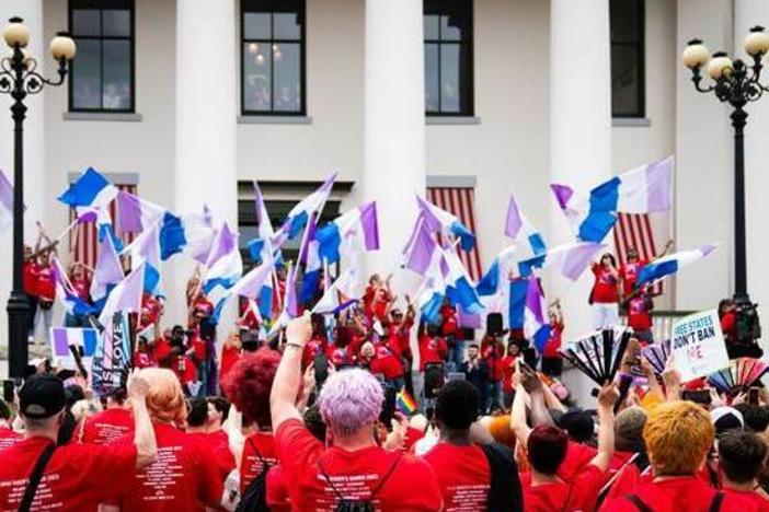 Advocates outside Florida's historic Capitol wave drag pride flags during the Drag Queens March in 2023.