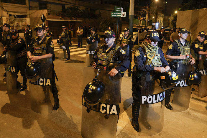 Police guard outside President Dina Boluarte's house during a raid ordered by the Attorney General's Office aimed at seizing luxury watches as part of a preliminary investigation into alleged illicit enrichment in Lima, Peru, Saturday, March 30, 2024.