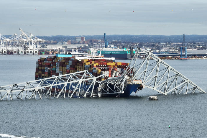 A steel frame from the collapsed Francis Scott Key bridge in Baltimore covers the top of the Dali ship. The container ship crashed into the bridge on Tuesday.
