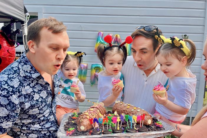 Eric Portenga and Kevin O'Neill with daughters Sylvie, Robin and Parker O'Neill celebrating the girls' 2nd birthday in Sept. 2023. The babies' surrogate lived in Ohio because of Michigan's laws, that are changing now.