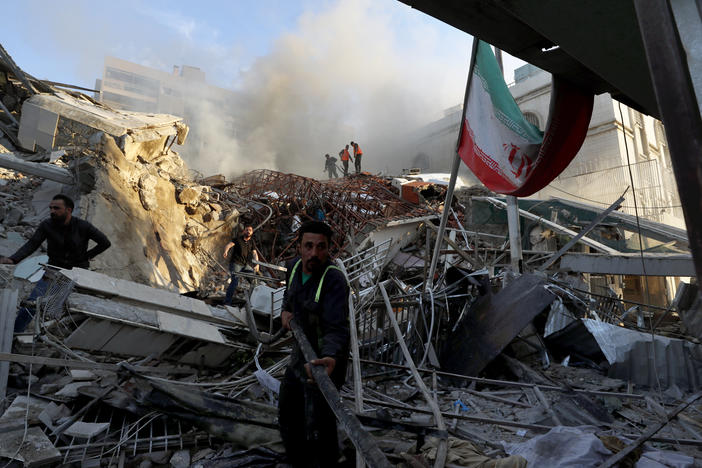 Emergency services work at a building hit by an air strike in Damascus, Syria, Monday.  Iran's consulate in Damascus was demolished and two Iranian generals were among those killed, Syrian and Iranian officials said.