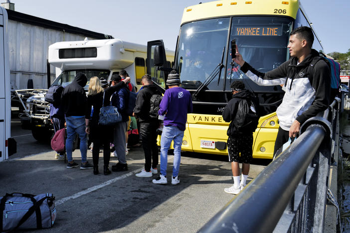 Venezuelan migrants gather at the Vineyard Haven ferry terminal in Marthas Vineyard. The group was transported to Joint Base Cape Cod in Buzzards Bay.