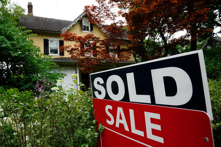 A sold sign stands outside a home in Wyndmoor, Pa., on June 22, 2022. Two recent studies suggest that prospective homeowners will have to earn more than $100,000 annually to afford a typical home in much of the U.S.