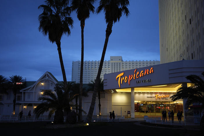 People walk outside of the Tropicana hotel-casino March 28 in Las Vegas. The property closed on Tuesday.
