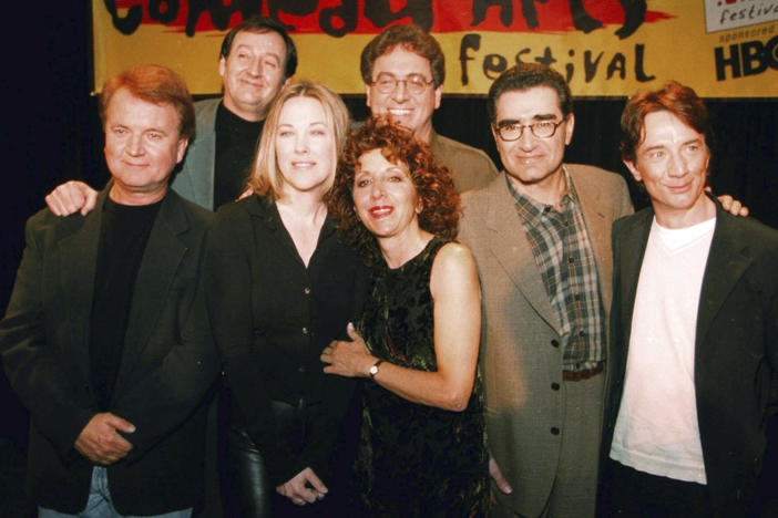 Former cast members of SCTV Dave Thomas (from left), Joe Flaherty, Catherine O'Hara, Andrea Martin, foreground, Harold Ramis, Eugene Levy and Martin Short, pose at the U.S. Comedy Arts Festival on March 6, 1999, in Aspen, Colo. Flaherty, a founding member of the Canadian sketch series "SCTV," died Monday at age 82.