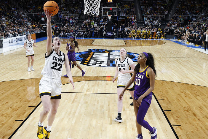 Caitlin Clark of the Iowa Hawkeyes shoots the ball over Angel Reese of the LSU Tigers during the first half in the Elite 8 round of the NCAA Women's Basketball Tournament at MVP Arena on April 1, 2024 in Albany, New York.