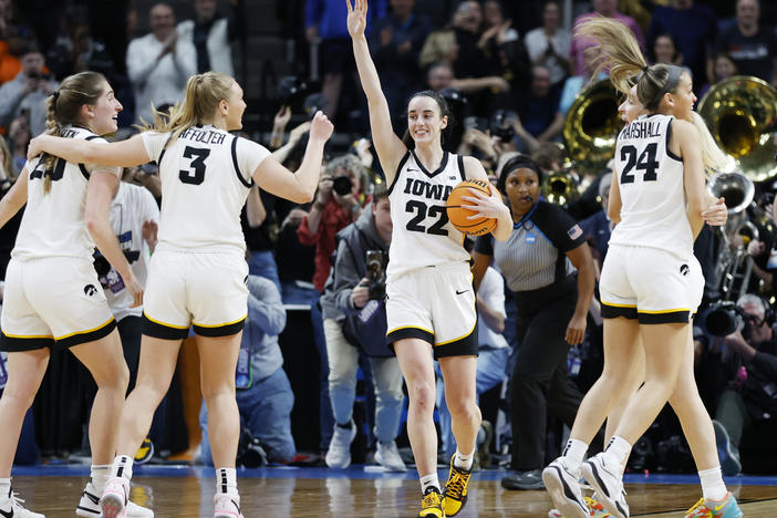 Caitlin Clark, #22 of the Iowa Hawkeyes, and her teammates celebrate after beating Louisiana State 94-87 in the Elite Eight round of the NCAA women's tournament on Monday.