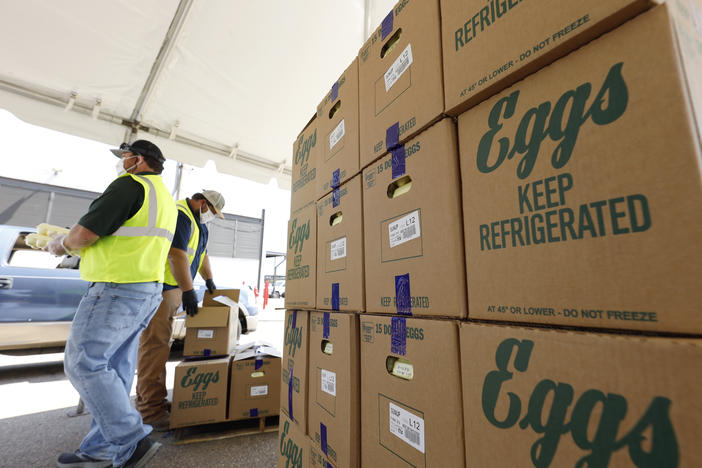 Cases of eggs from Cal-Maine Foods, Inc., await to be handed out by the Mississippi Department of Agriculture and Commerce employees at the Mississippi State Fairgrounds in Jackson, Miss., on Aug. 7, 2020.