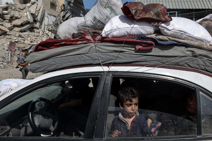 A young boy looks out from a car as members of a Palestinian family leave Rafah in the southern Gaza Strip with personal belongings on March 31.