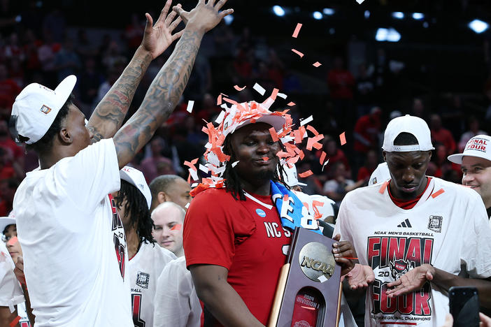 DJ Burns Jr. of the North Carolina State Wolfpack is showered with confetti after advancing to the Final Four.