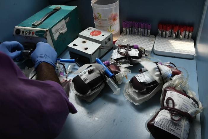 A worker separates bags of donated blood at a campaign organized by the Rotary Blood Bank in New Delhi, India.