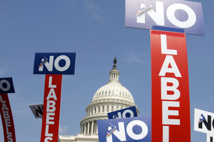 People with the group No Labels hold signs during a rally on Capitol Hill in 2013. No Labels says it won't field a presidential candidate in November after strategists for the bipartisan organization were unable to attract a candidate willing to seize on the widespread dissatisfaction with President Joe Biden and Donald Trump.