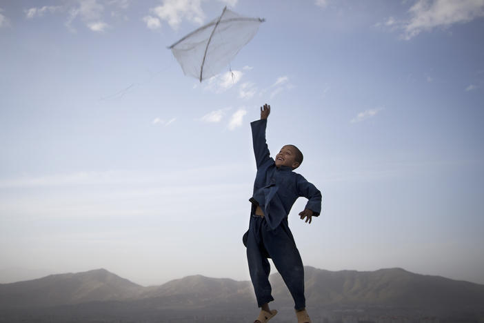 In this photo made by Associated Press photographer Anja Niedringhaus, an Afghan boy flies his kite on a hill overlooking Kabul, Afghanistan, May 13, 2013.