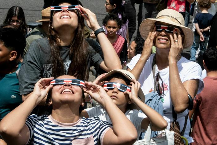 People watch the annular eclipse of the sun at the planetarium of the University of Costa Rica (UCR) in San Jose, on October 14, 2023.