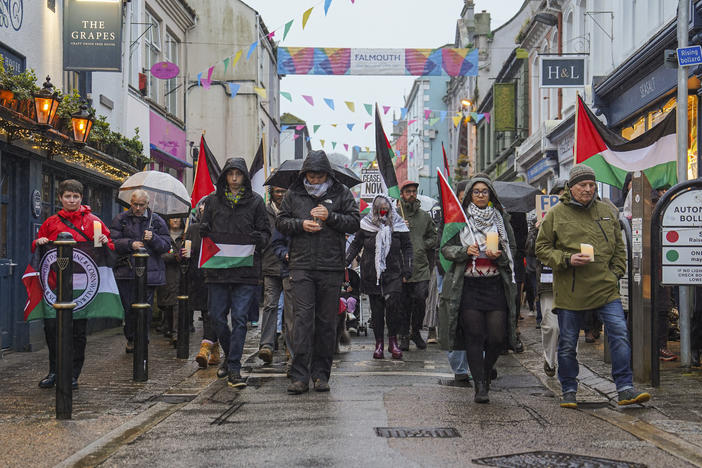 Members of the public join a walking vigil through the streets of Falmouth, England, for British aid worker James Henderson, organized by Palestine Solidarity Cornwall, April 3. Three British men working for World Central Kitchen were killed along with four colleagues when their clearly marked vehicles were targeted by Israeli military strikes.