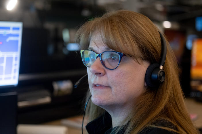 Linda Anderson, an emergency communications technician, responds to a call at the Denver 911 dispatch center.