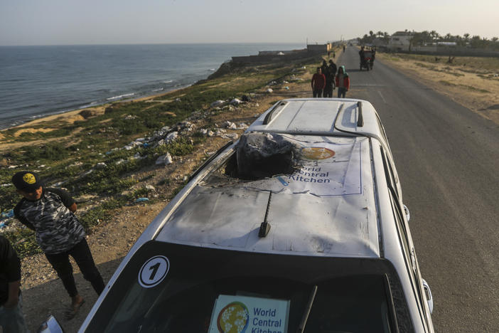 Palestinians inspect a vehicle with the logo of the World Central Kitchen wrecked by an Israeli airstrike in Deir al Balah, Gaza Strip.