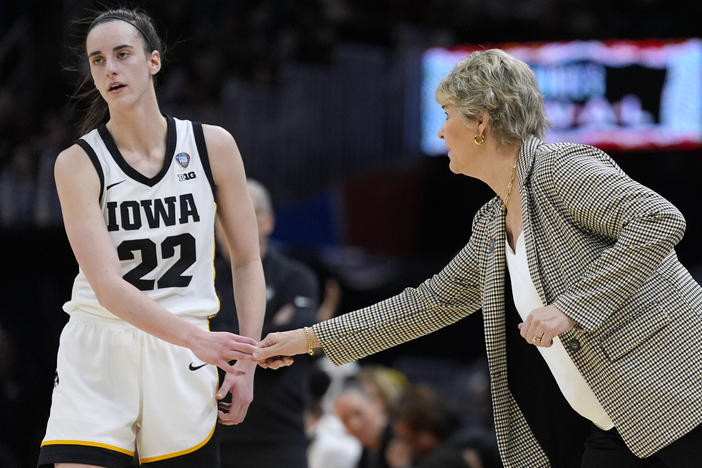Iowa guard Caitlin Clark (22) with head coach Lisa Bluder during a Final Four college basketball game against UConn in the women's NCAA Tournament, Friday, April 5, 2024, in Cleveland.