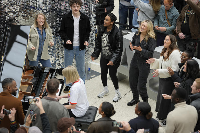 Members of the Mark de Lisser Singers perform the iconic ABBA song 'Waterloo' at Waterloo Station in London on Saturday, April 6, 2024.