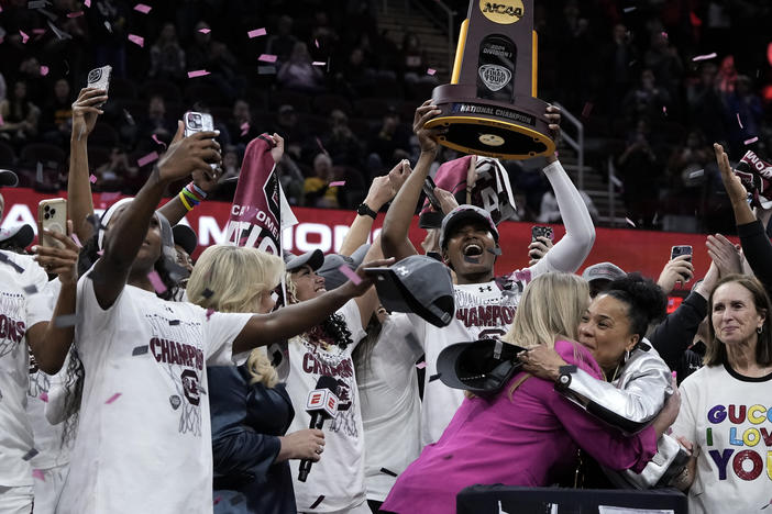 South Carolina's players and coach celebrate after the college basketball championship game against Iowa in the women's NCAA Tournament on Sunday. South Carolina won 87-75.