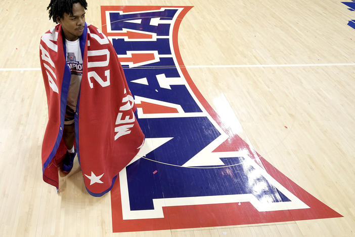 Freed-Hardeman guard Quan Lax wears the championship banner after the NAIA men's national championship college basketball game against Langston, Tuesday, March 26, 2024, in Kansas City, Mo.