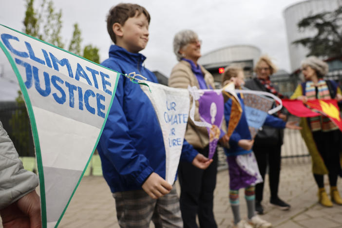 People demonstrate outside the European Court of Human Rights Tuesday, April 9, 2024 in Strasbourg, eastern France.