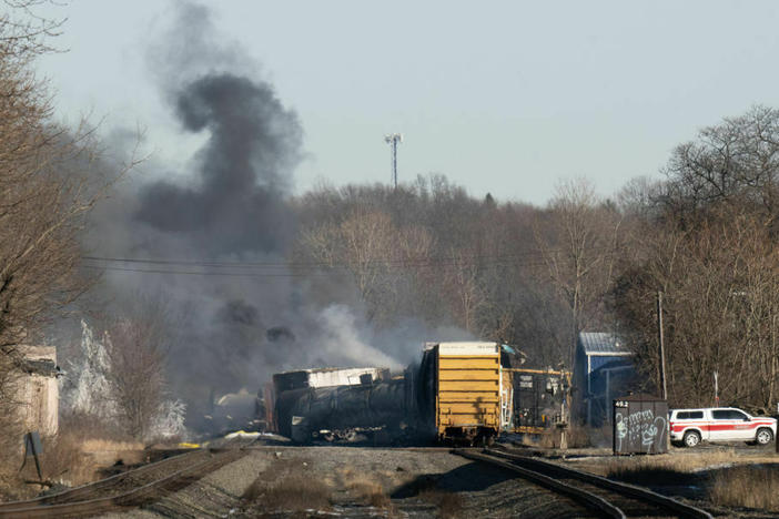 Smoke rises from a derailed cargo train in East Palestine, Ohio, in February of 2023.