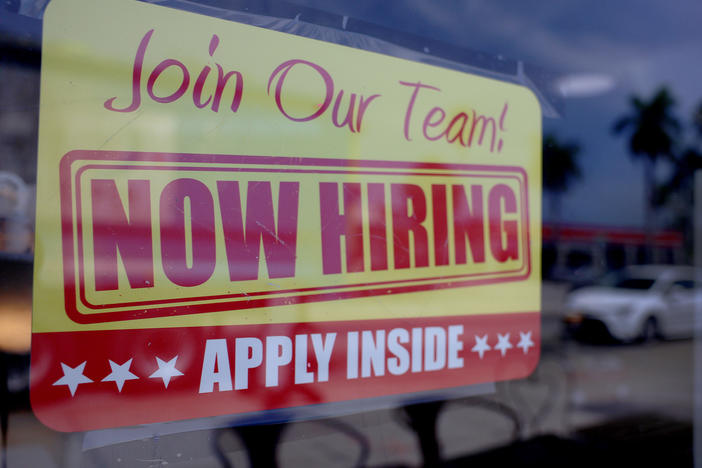 A sign seeking job applicants is seen in the window of a restaurant in Miami, Florida, on May 5, 2023.