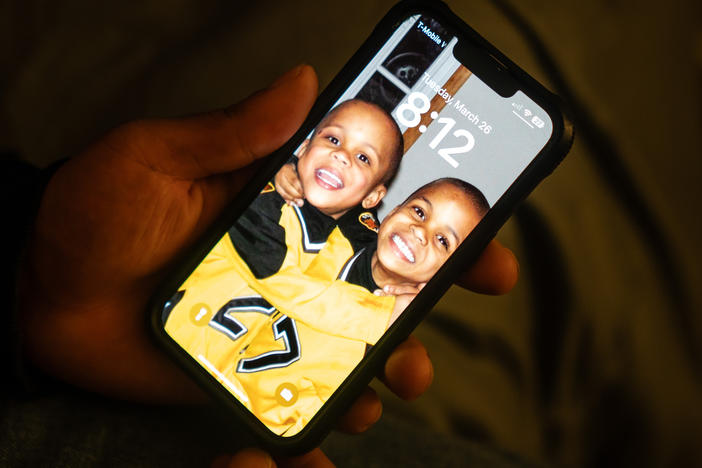 Zion Kelly keeps a screensaver on his phone of he and his brother as young kids.