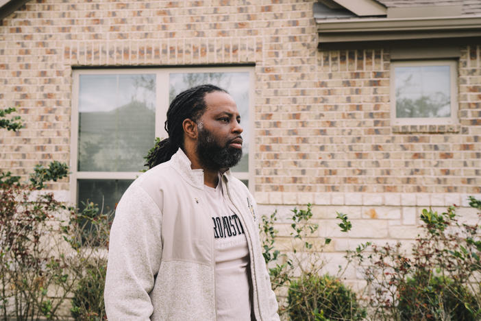 Edmund Garcia, an Iraq War veteran, stands outside his home in Rosharon, Texas. Like many vets, he was told if he took a mortgage forbearance, his monthly payments wouldn't go up afterward.
